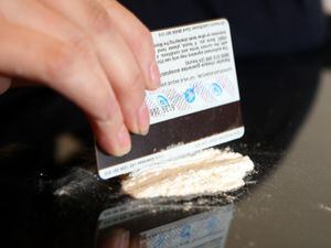 Mock-up picture of a person cutting cocaine
