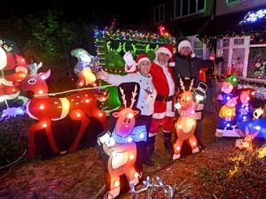Nick and Julia Barnard from Westbrook Avenue, Aldridge, with their amazing Christmas decorations. They have been doing it for charity for over 30 years. Pictured with the couple is their son Ben..