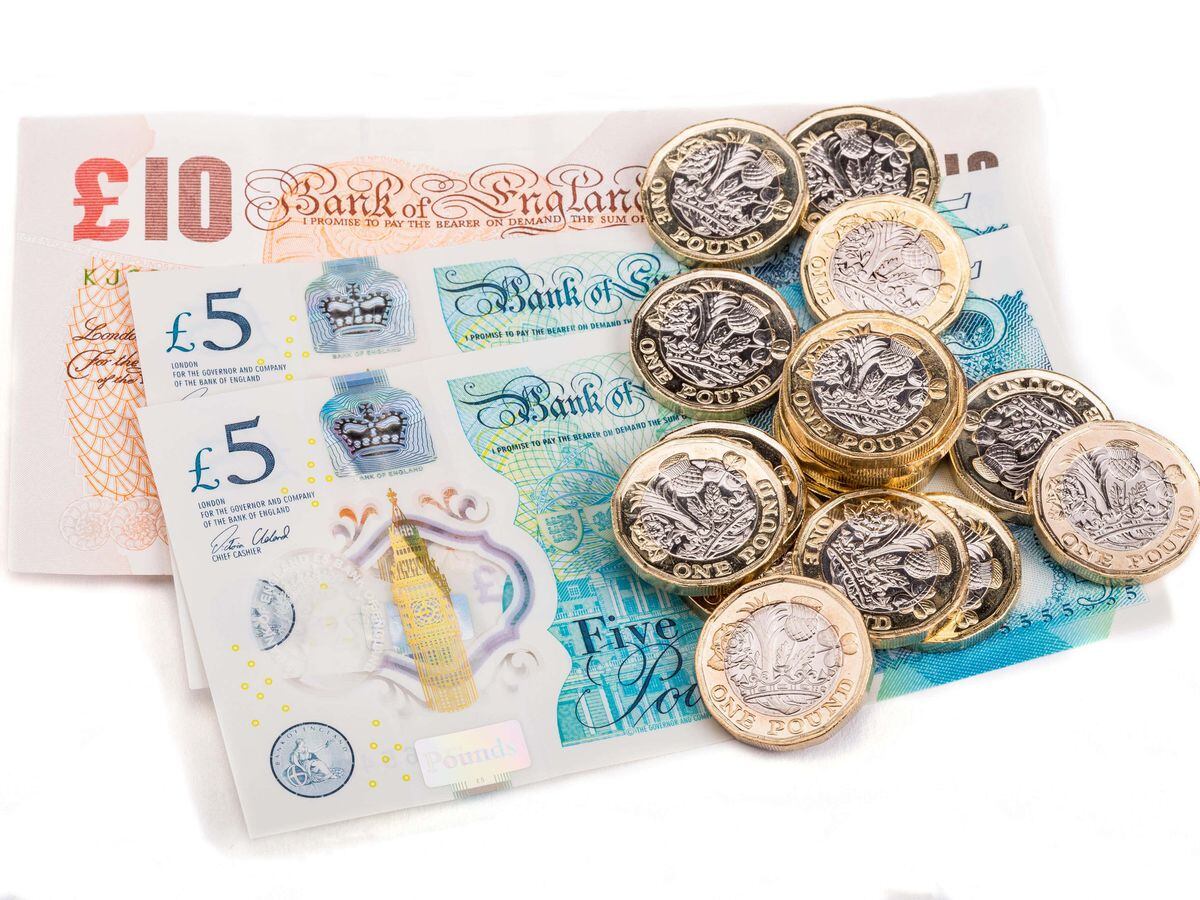 British one pound coins on British bank notes