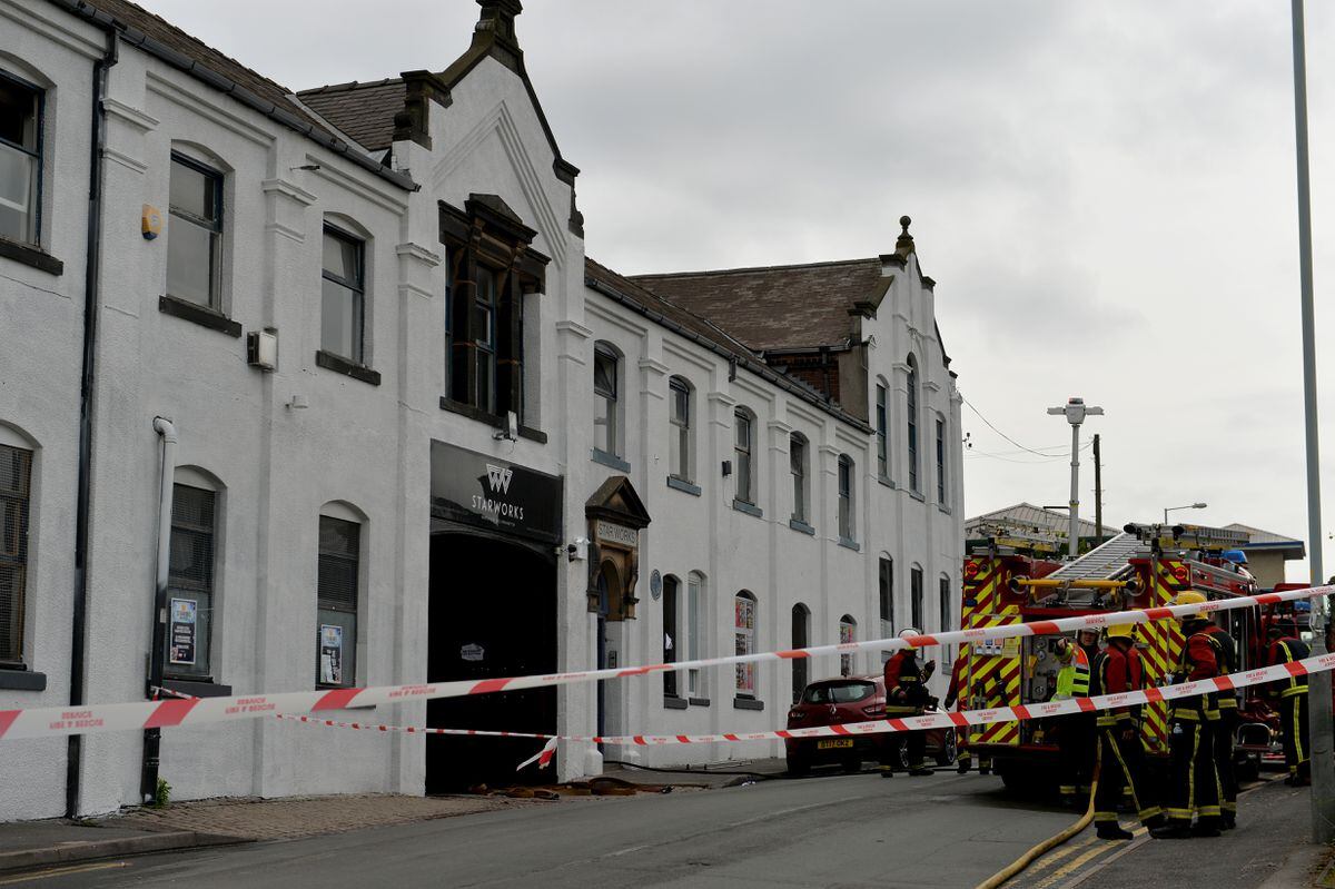 Fire crews taped off the street while they tackled the blaze 