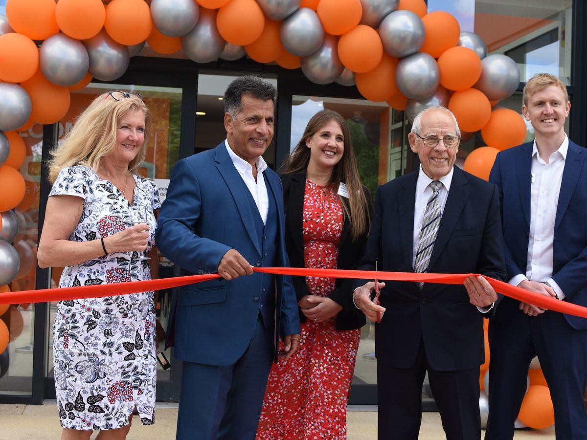 Peter Coates, second from right, cuts the ribbon with, from left, Ann Chaudry, Mo Chaudry, Shanie Chaudry-Goodall, and Wayne Goodall