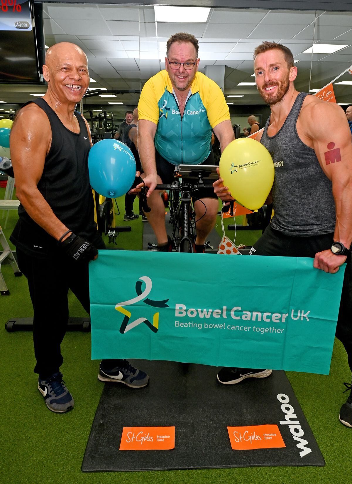 Adrian Sims is attempting to ride 1000 miles on an exercise bike at Village Hotel, Walsall, in memory of his fianceé Cheryl McBreen. He is pictured with friends Ishvar Rana and Dan Kibby.