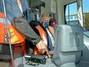 Boris Johnson takes control of one of the trams as he visits Midland Metro's Wednesbury depot