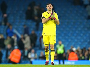 Aston Villa goalkeeper Emiliano Martinez applauds .
