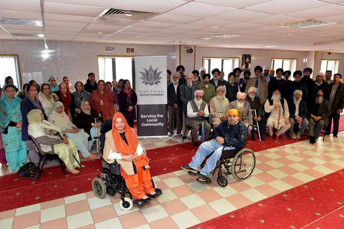 Dee Kaur and Malkit Singh are pictured with temple users and members of the Wolverhampton Sikh Forum
