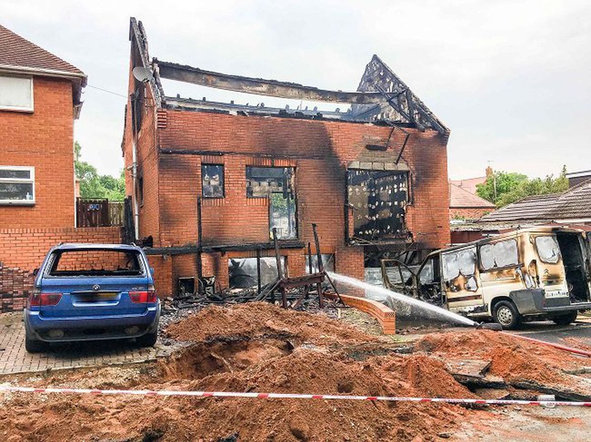 The remains of the home in Huntsmans Walk, Kinver and vehicles after the fire