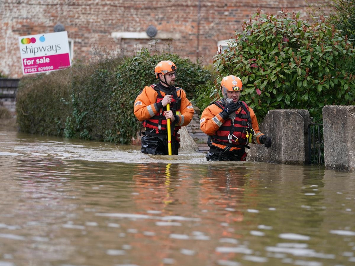A fire and rescue team wades through the flood water at Bewdley, where river levels are expected to peak on Wednesday afternoon. Photo: Joe Giddens/PA Wire