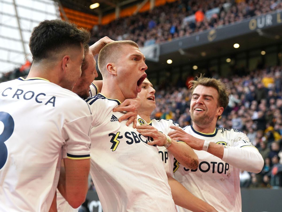 Leeds' Rasmus Kristensen, centre, celebrates his goal