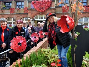 Sharon Felton, right, with people who have helped create a striking poppy display at Darlaston Town Hall