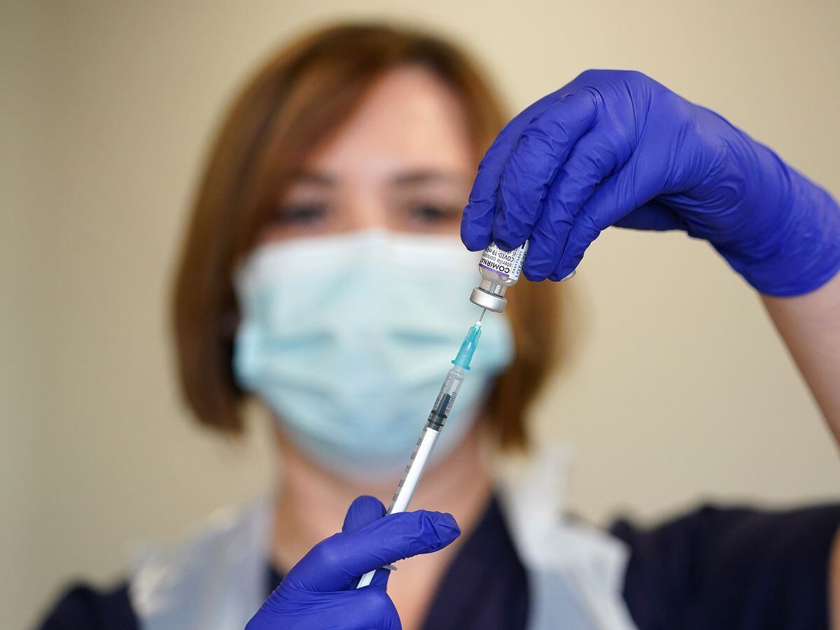 Nurse Heather Esmer draws a syringe before administering a Covid-19 vaccine booster at Birkenhead Medical Building in Merseyside