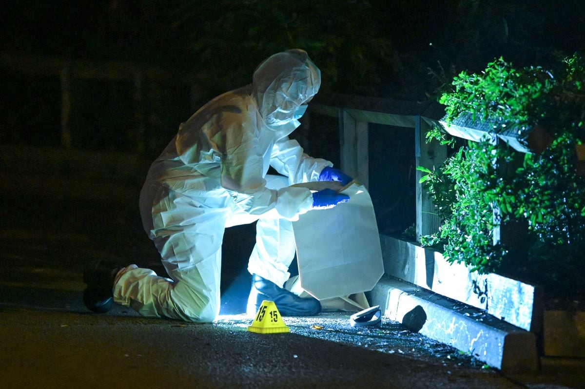 A forensic officer at the scene on Monday evening. Photo: SnapperSK
