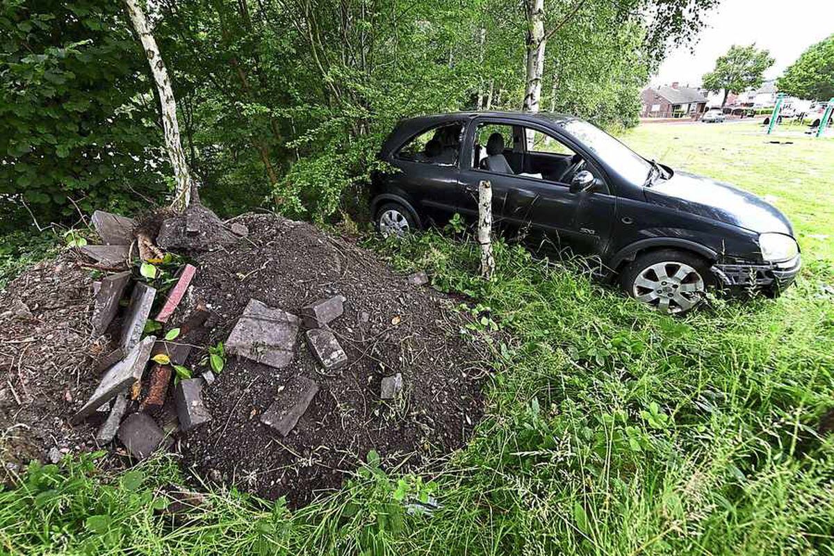 Even a car has been dumped, alongside a heap of soil