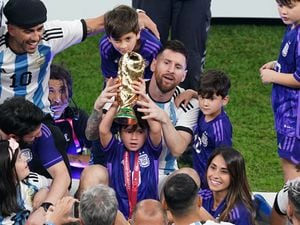Argentina’s Lionel Messi sits with family members after the World Cup final