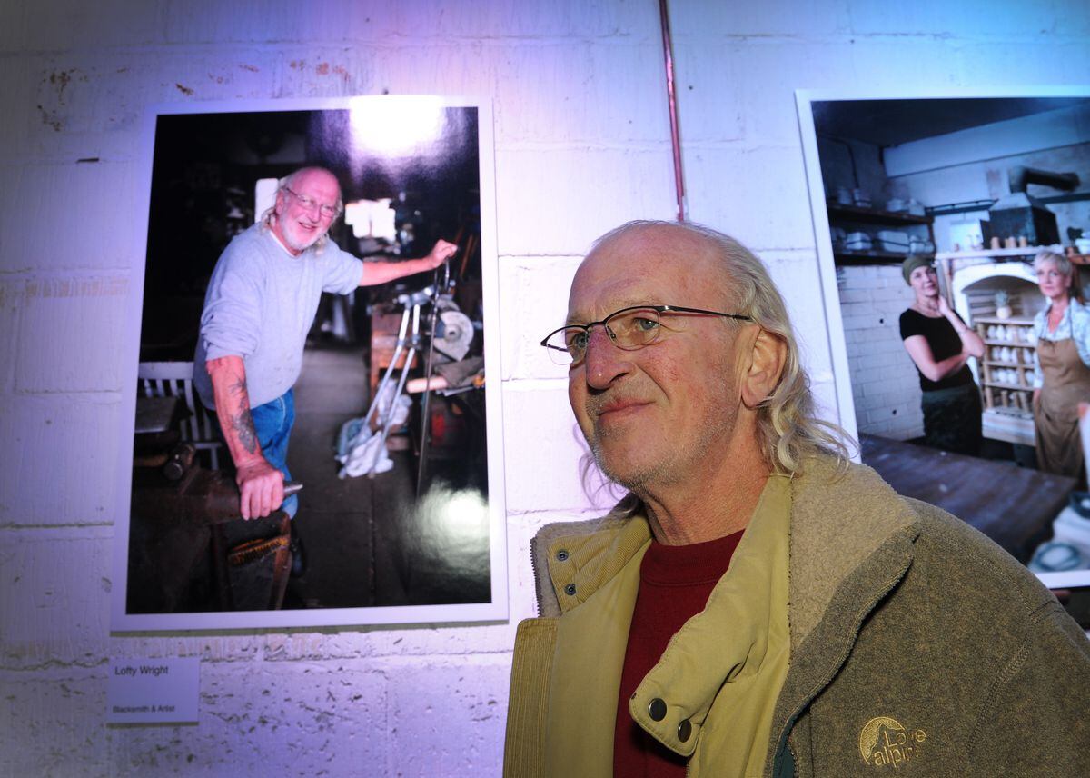 Looking at a photograph of himself in the display is blacksmith artist Lofty Wright, of Darlaston