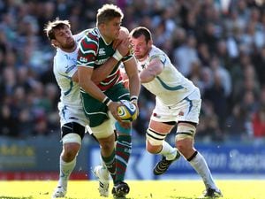 Leicester's Ed Slater is tackled by Aly Muldowney and Tom Hayes of Exeter