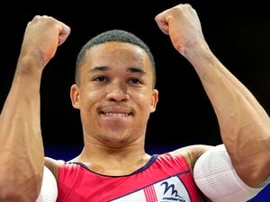 Britain's Joe Fraser reacts after winning the men's parallel bars final at the European Gymnastics Championships in Munich, Germany, Sunday, Aug. 21, 2022. (AP Photo/Pavel Golovkin).