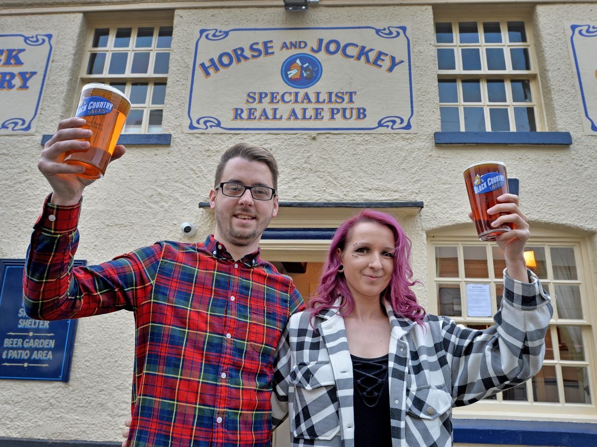 Landlord Michael Lawrence and wife Leoh Flood celebrate the horse and Jockey reopening