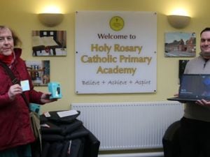 Councillor Anwen Muston, left, delivering the digital equipment to Holy Rosary principal Adam Jewkes