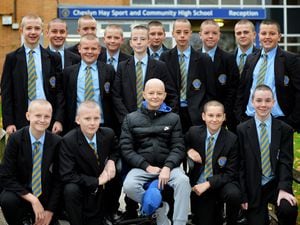 Lucas Tibbs, centre, surrounded by his school friends who all had their heads shaved in support of his cancer battle