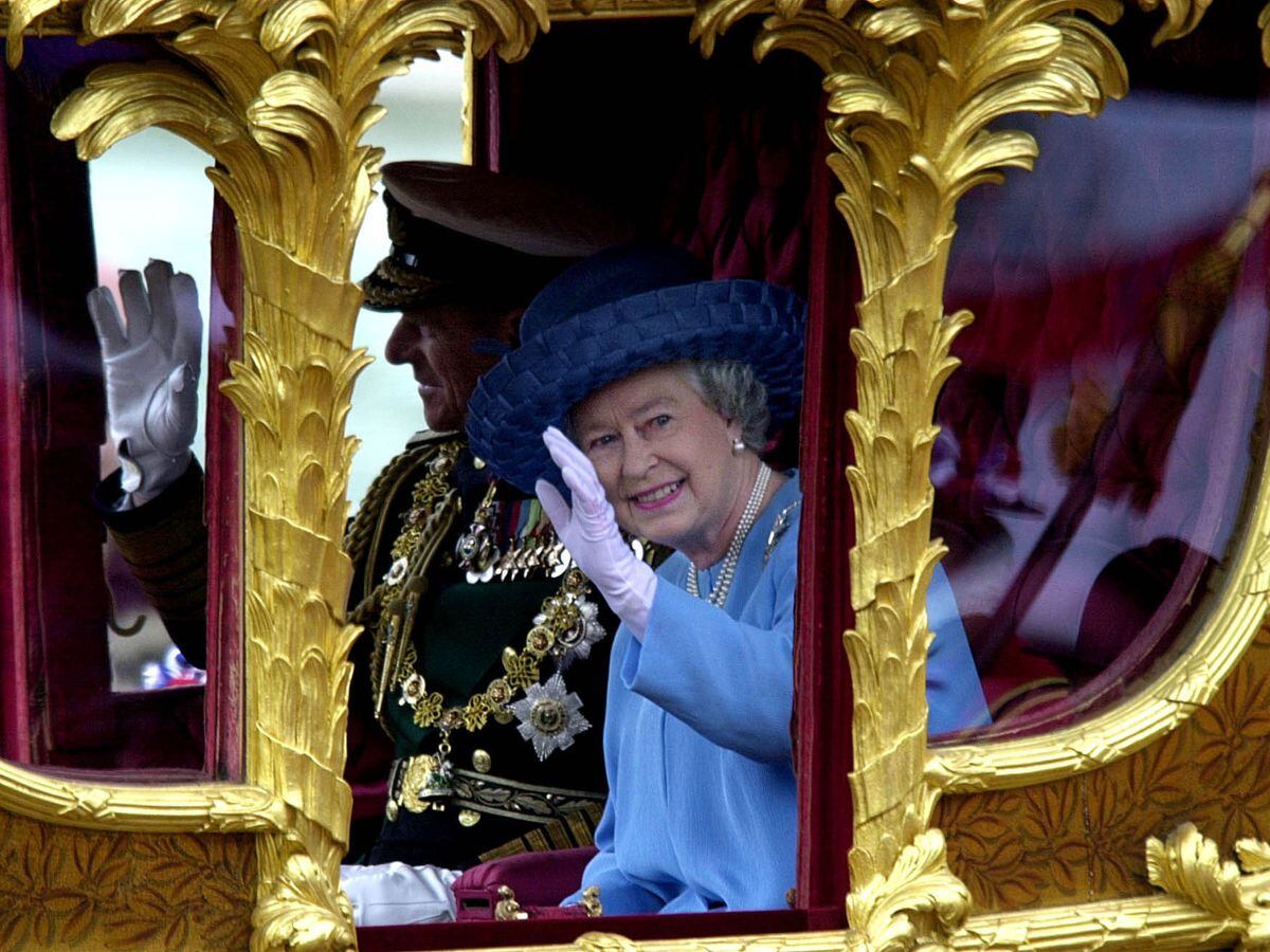 The Queen riding in the famous gold state coach