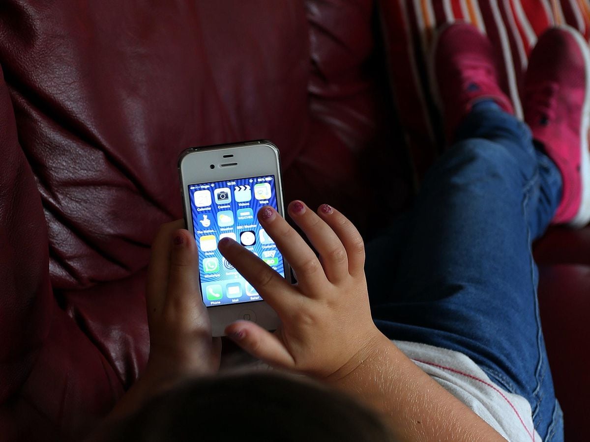 A child using an Apple iPhone smartphone (Peter Byrne/PA)