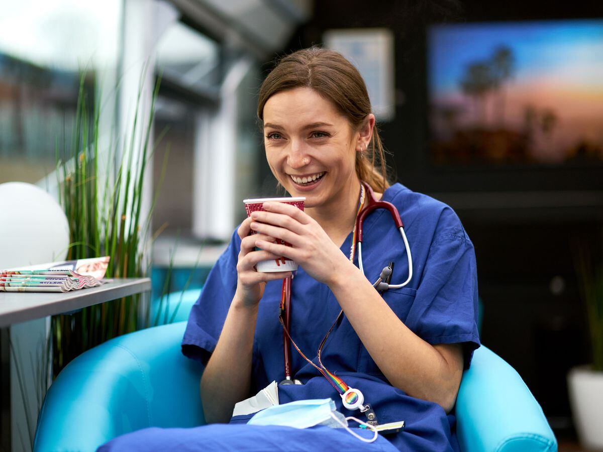 An NHS worker enjoys a cuppa