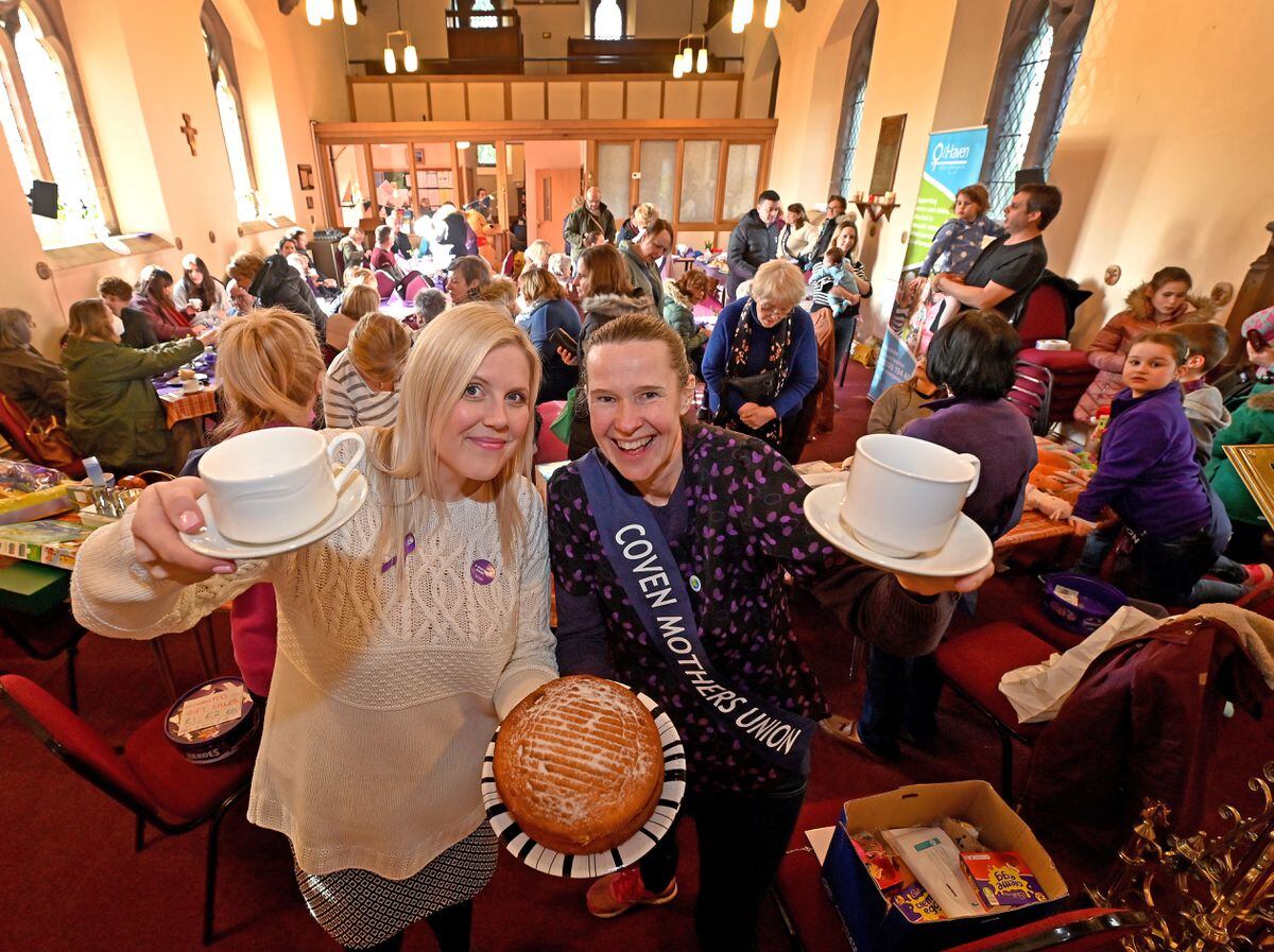 Hayley Powell and Jo Knight raise a cup at the community event