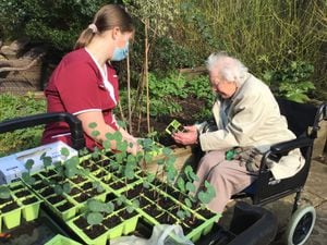 Foxland resident teaches younger staff her gardening tips