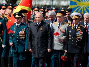 Russian President Vladimir Putin, centre, attends a wreath-laying ceremony at the Tomb of the Unknown Soldier after the military parade marking the 77th anniversary of the end of the Second World War, in Moscow, Russia, on Monday May 9 2022