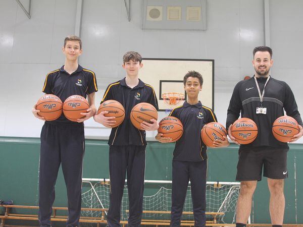 Perryfields students Hayden Weston, 13, Dexter Gooding, 13 and Dylan Swain-Boateng, 14 with PE teacher Archie Bryan