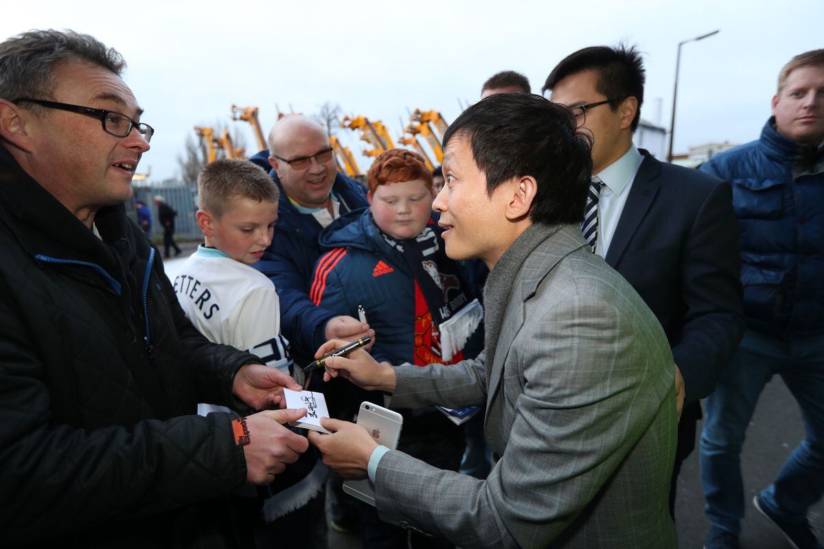 Owner of West Bromwich Albion Guochuan Lai stops to sign autographs for West Bromwich Albion Fans on his arrival at the stadium 