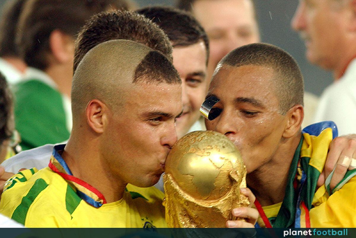 Brazil's Ronaldo and Gilberto Silva kiss the World Cup