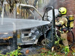 Trainee firefighter Jamie Gunn extinguishes the van fire in Greenfield Avenue, in Cradley Heath