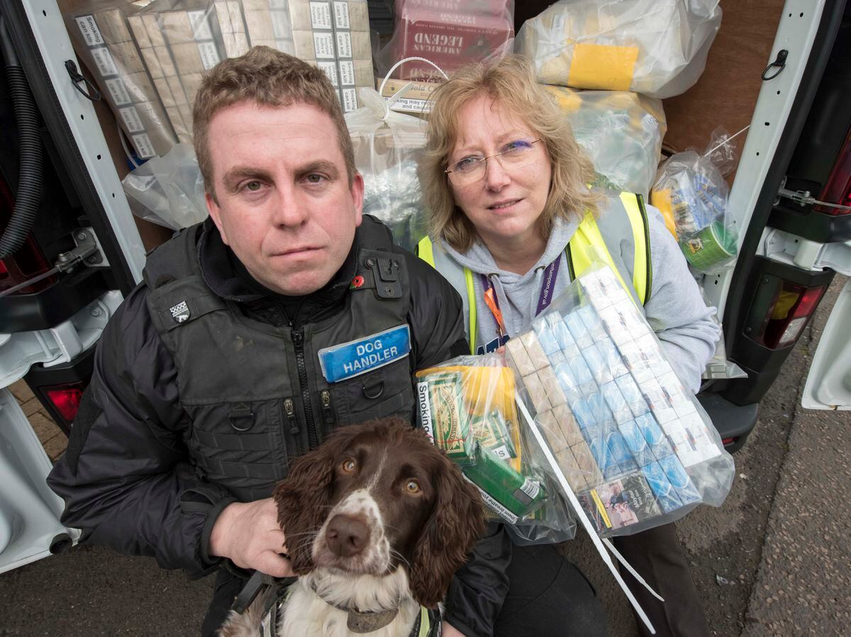 Dog handler Stuart Phillips and Wolverhampton trading standards officer Dianne Slack pictured with tobacco detection dog Scamp