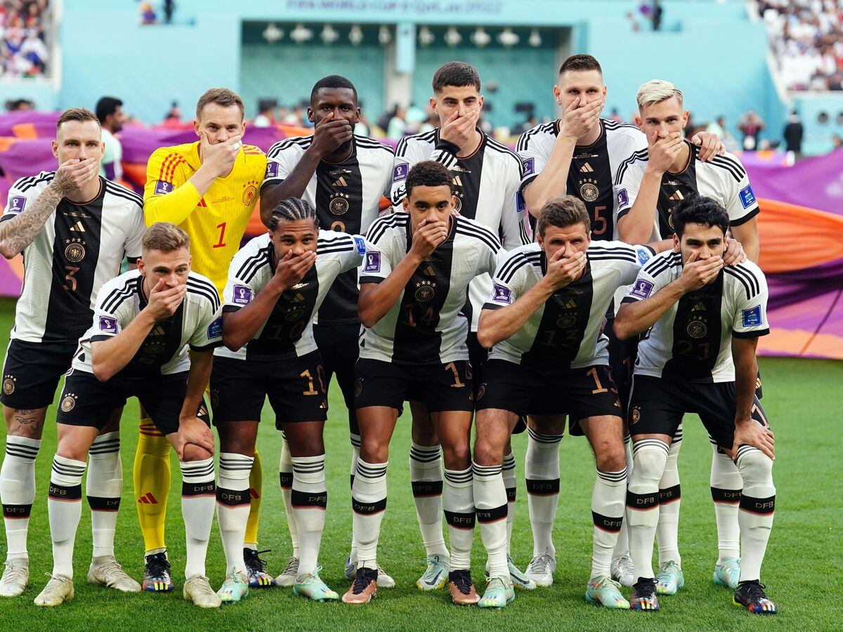 Germany players cover their mouths as a protest against FIFA