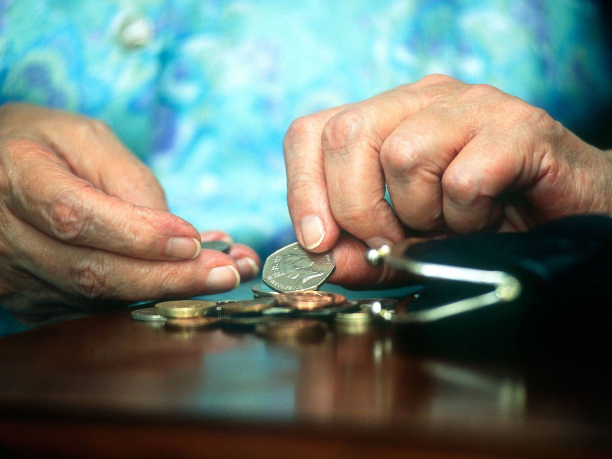 Elderly woman counting her money, UK