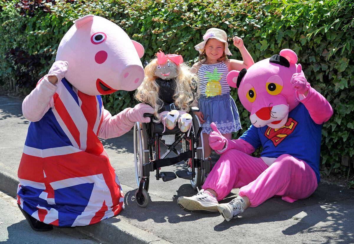 Stuart Bailey and Earl Edwards with five year old Amelia-Mae Smith, who has created a scarecrow in a wheelchair based on herself