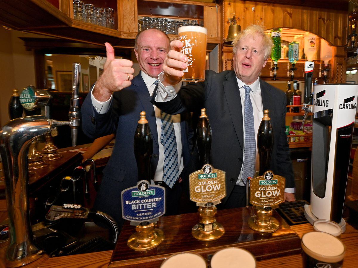 Boris Johnson pulling a pint alongside Marco Longhi MP at The Park Inn during a visit to Holden's Brewery