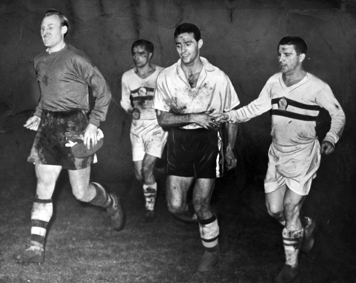 Wolves v Honved at Molineux, December 1954, featuring the luminous shirts. The original caption read: “Hungarian and Honved skipper Ferenc Puskas showed his sportsmanship through a handshake for Wolves full back Eddie Stuart as the teams trooped off the field, Wolves dazed with success, Honved dazed in defeat. Bert Williams (left) grinned happily under his coating of Molineux mud.”
