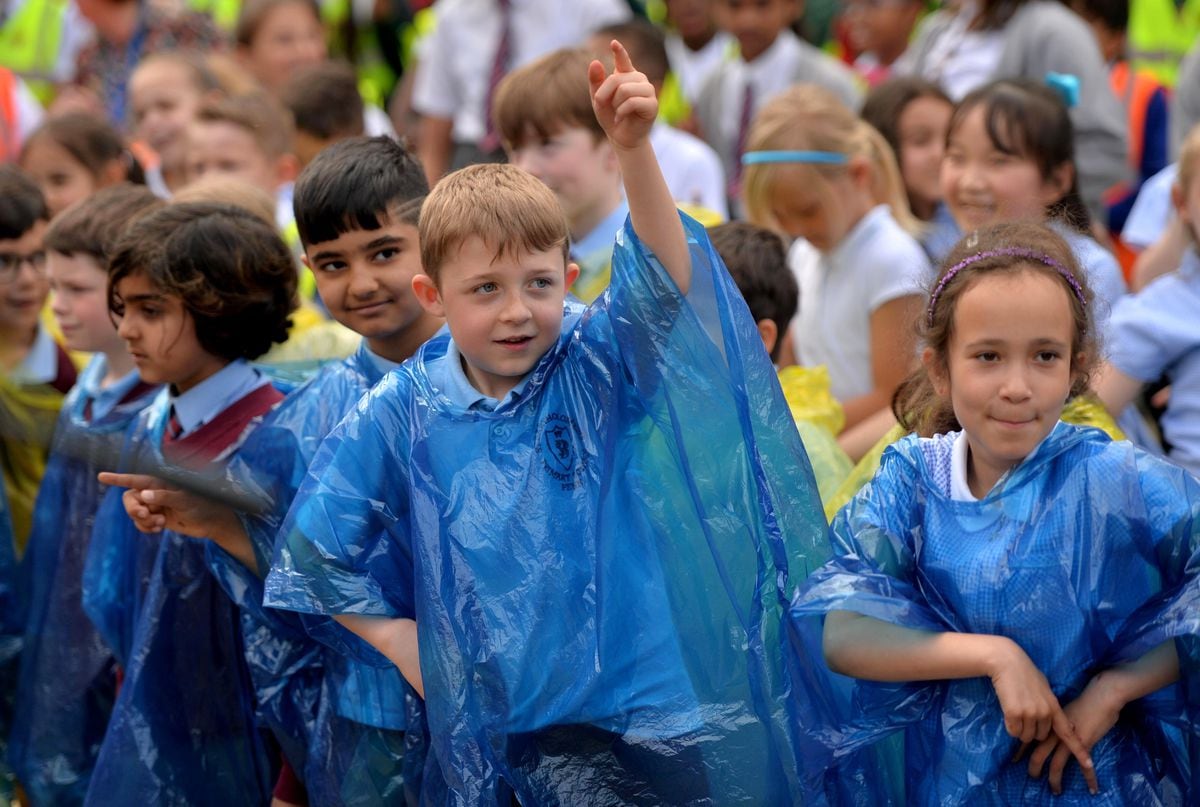Schoolchildren got into the swing of things despite the weather