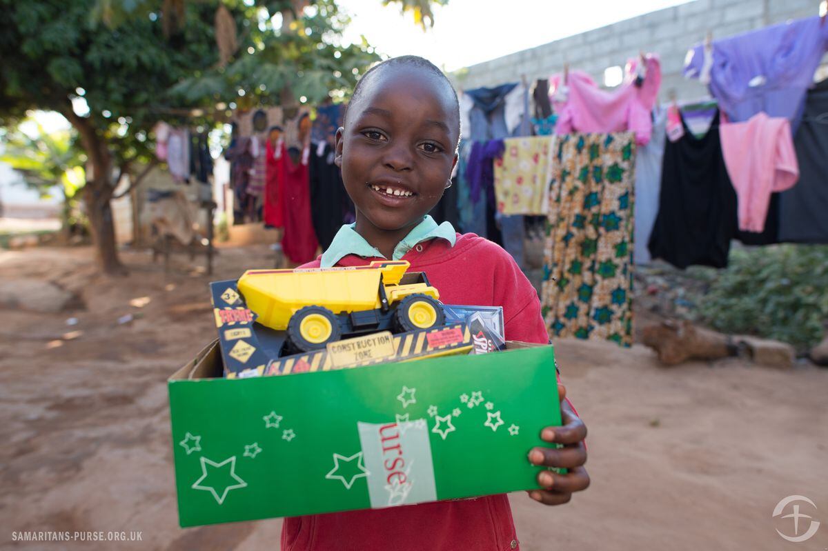 A boy in Zambia with his Christmas box
