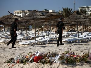 Police officers patrol the beach in Sousse, Tunisia, where 38 people lost their lives after a gunman stormed the beach