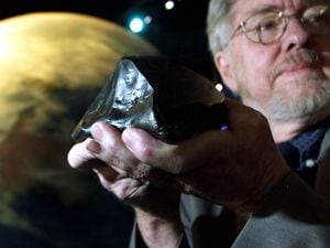 The Rowton meteorite was "special guest" at the 2002 opening of The Near Earth Objects information centre at the National Space Centre in Leicester. It is being held by Harry Atkinson, chairman of the Near Earth Object Taskforce.