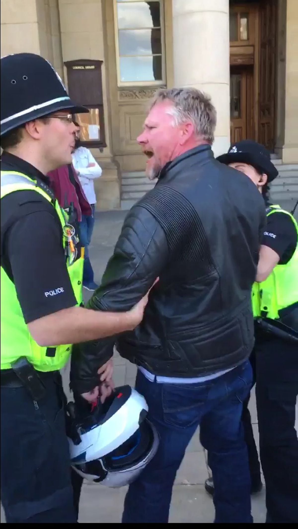 A member of the public had to be restrained after he reacted angrily to an anti-war speaker