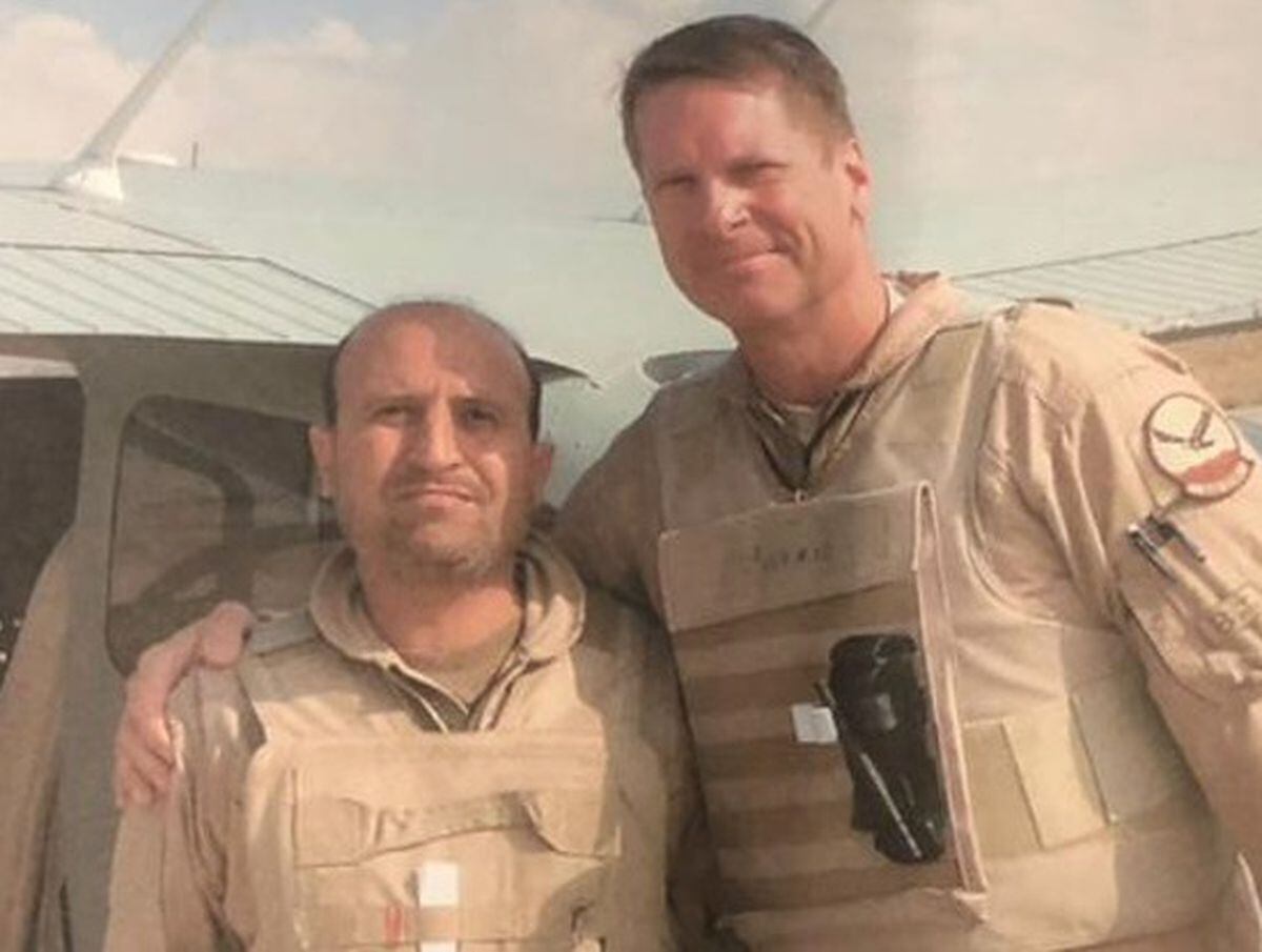 Pilot Major Shamsullah Shirzad, left, with a colleague in Afghanistan where he is currently in hiding from the Taliban.