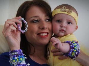 Making bracelets to raise money for charity, is Sam Carrier, of Dudley, with her daughter Daisy Evans, aged 6 months, who suffers from Cystic Fibrosis