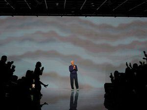 Designer Giorgio Armani accepts applause after the conclusion of his women’s spring-summer 2024 collection presented in Milan