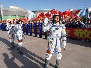 Chinese astronaut Chen Dong, right, waves as he walks ahead of fellow astronauts Liu Yang and Cai Xuzhe during a sendoff ceremony for the Shenzhou-14 crewed space mission at the Jiuquan Satellite Launch Centre
