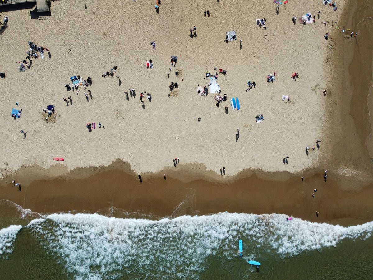 People enjoy the warm weather on Tynemouth Longsands beach, near Tynemouth in Tyne and Wear