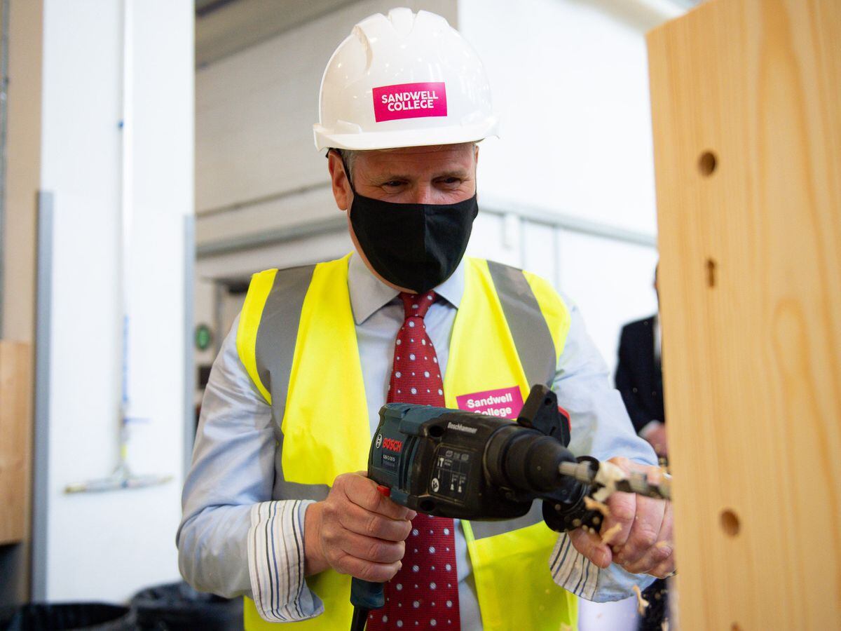Labour leader Sir Keir Starmer uses a drill in a woodwork class during a visit to Sandwell College in the West Midlands